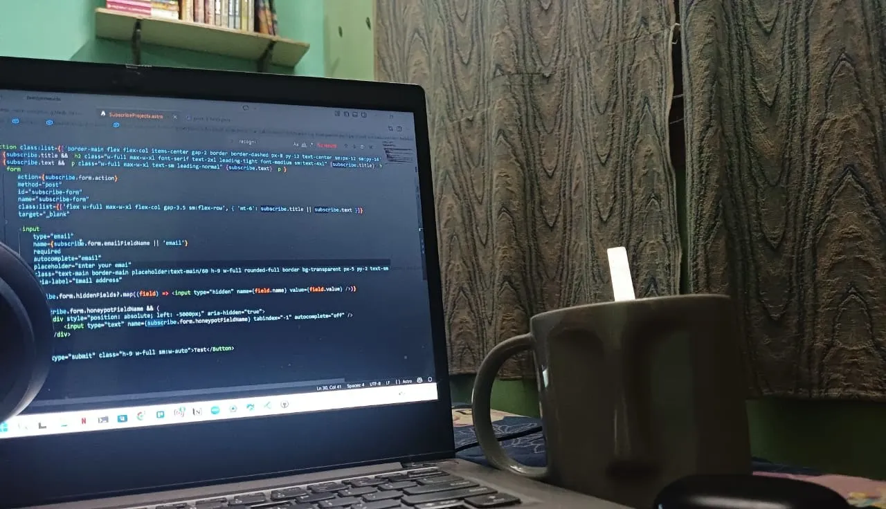 A desk with an open notebook, tablet, and Pantone colour swatches